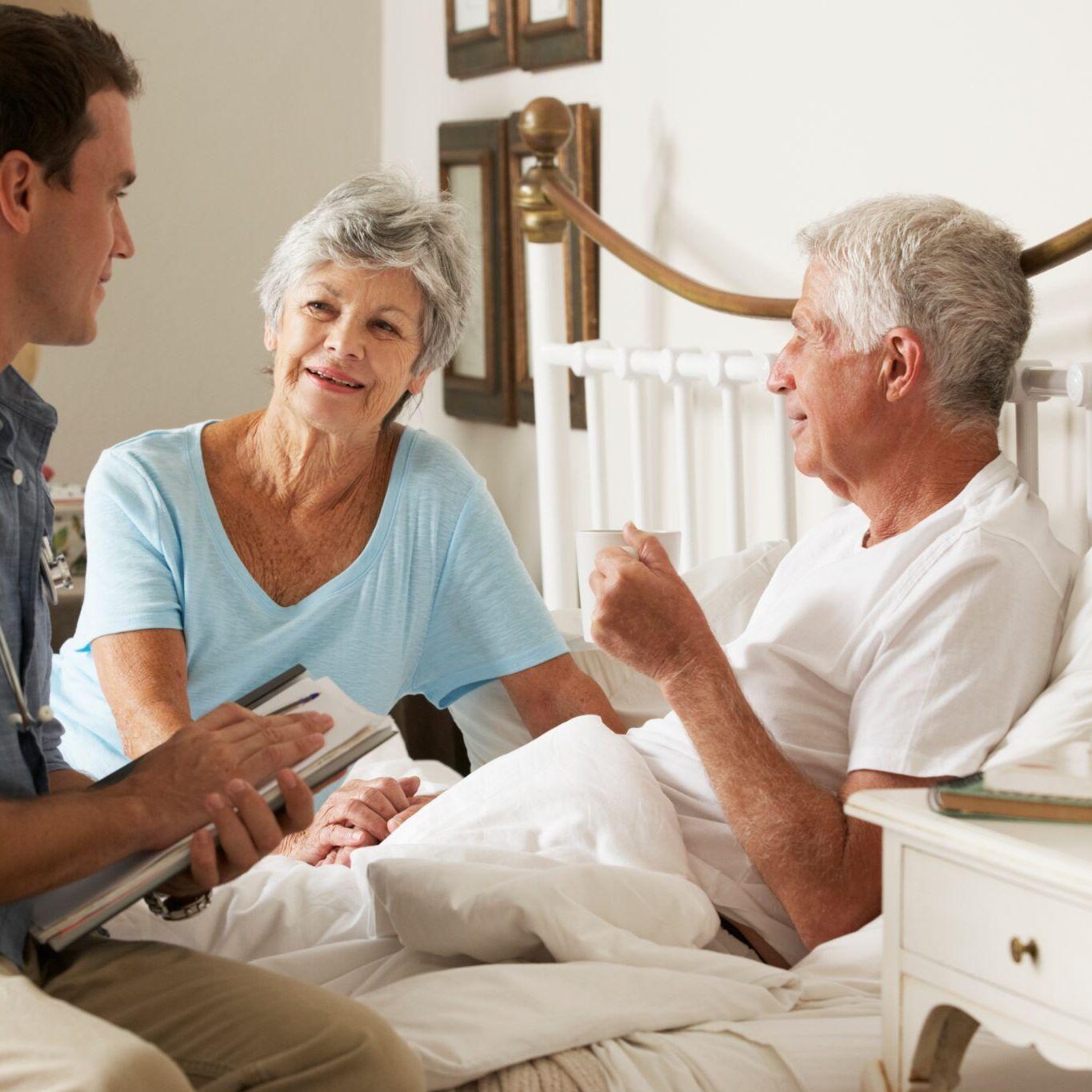 Elderly man receiving palliative care in his own home bed